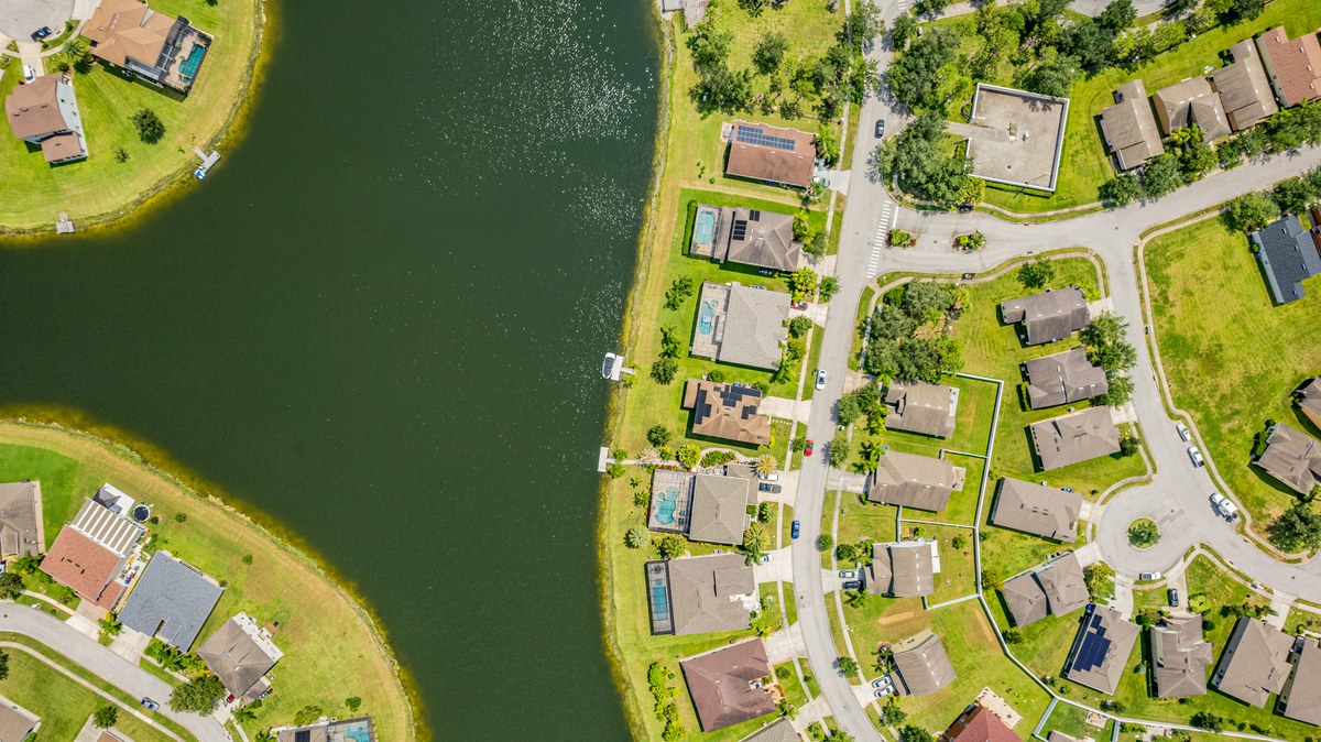 Aerial of the homes along the lake shore with their pools in Kissimmee