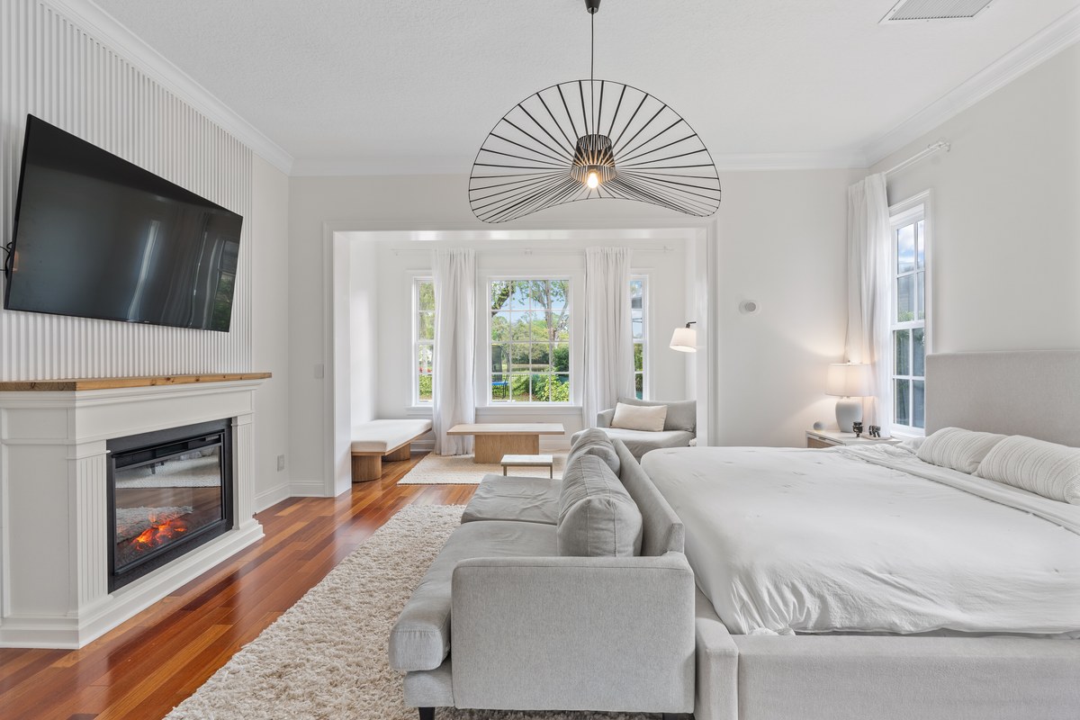Bedroom with a television over a fireplace facing the bed in Celebration