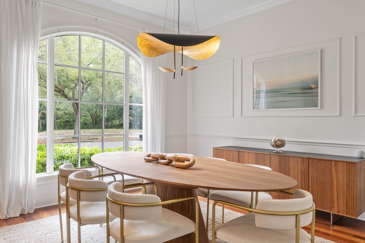 Dining area with an arched window and a gold pendant light in Celebration