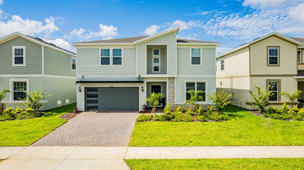 Elevated view of a sage green two-story home with a garage in Clermont