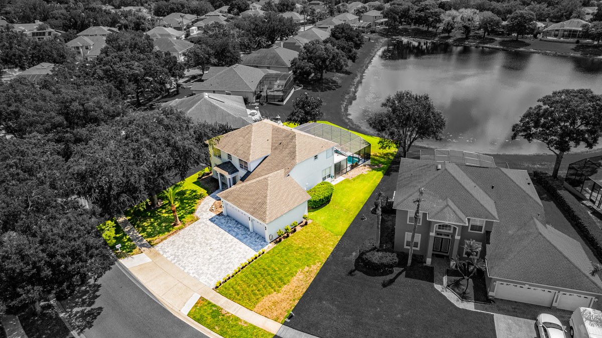 Black-and-white aerial of homes beside a lake in Orlando