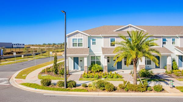 Elevated view of a townhome with a palm at the corner in Hamlin