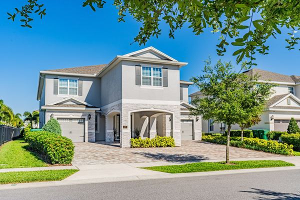 Two-story home with an arched entry seen from the corner in Kissimmee