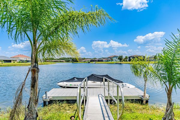 Dock with a covered boat lift on the lake in Kissimmee