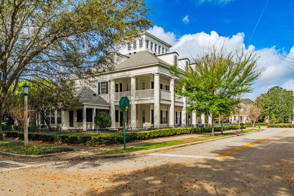 Large white colonial home with columns and wraparound porches in Orlando