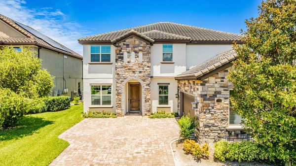 Elevated view of a stone and stucco home with a tile roof in Windermere