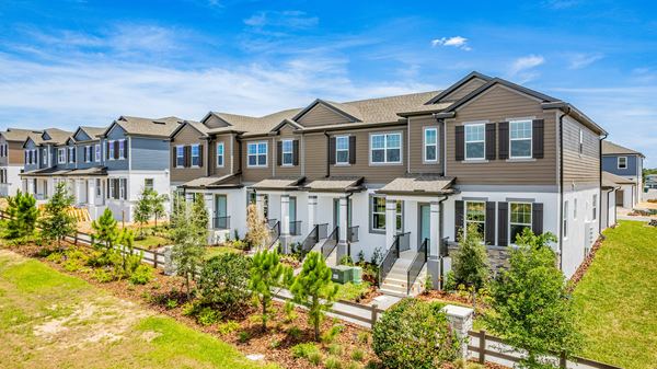 Elevated view of a townhome row behind a rail fence in Winter Garden