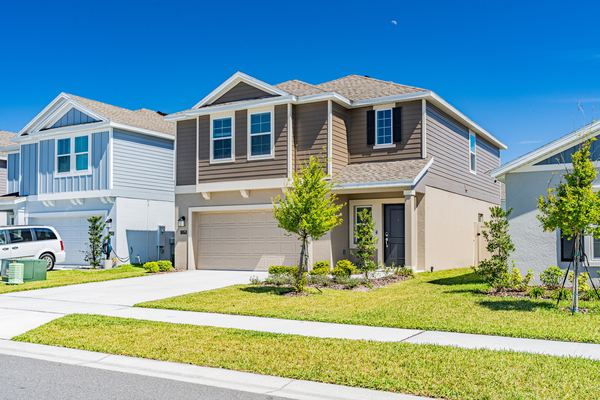 Blue and gray two-story home with a two-car garage in Winter Haven